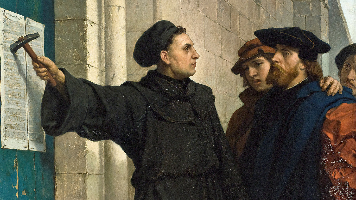 Kazatel Martin Luther přibijí na dveře kostela v německém Wittenbergu svých 95 tezí, 1517