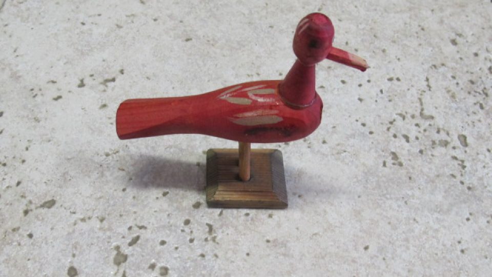 Soustružená, dřevěná hračka představující ptáčka. Hračka pochází ze Skašova. Nedatována