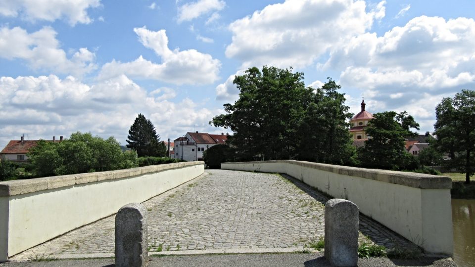 Za mostem vlevo vykukuje unikátní kostel Svatého Víta