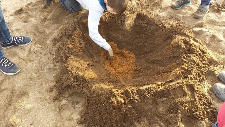 Děti zkoumají různobarevné písečné vrstvy na vlkovské duně