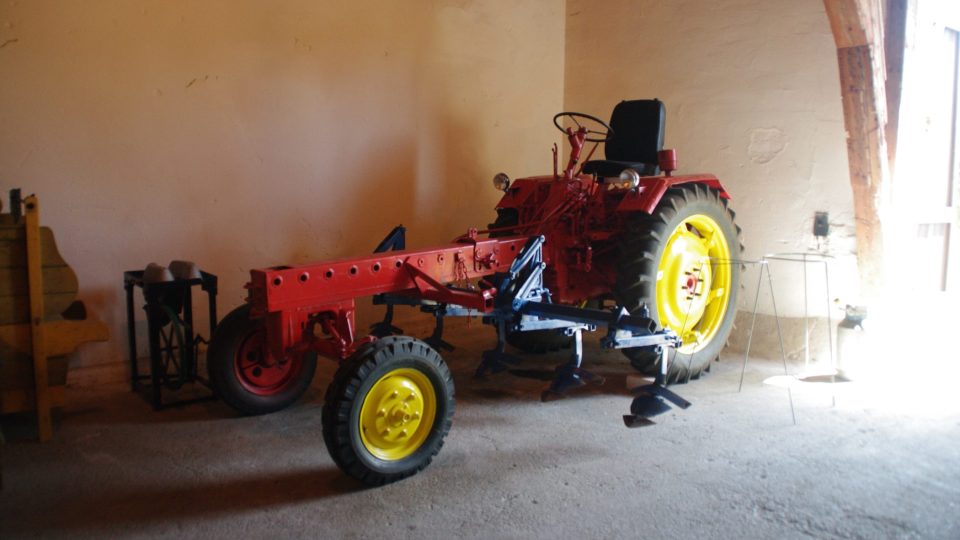 Traktor ze 60. let dodnes sem tam vyjede z muzejní expozice prohrnout řádky brambor na družstevním poli